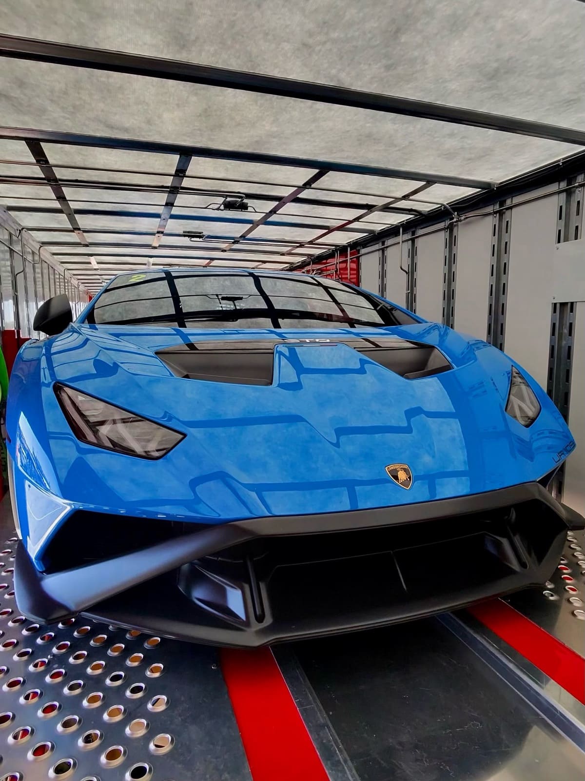 Blue Lamborghini Huracán STO loaded inside a VIY Transport enclosed trailer